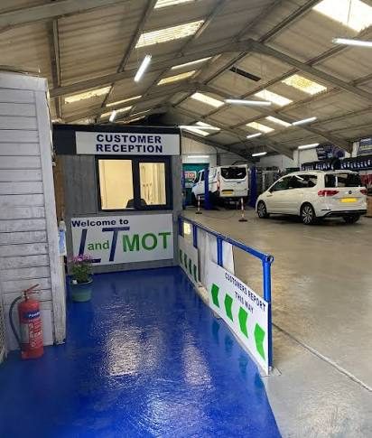 L&T MOT customer reception desk inside the workshop, with directional floor markings guiding customers